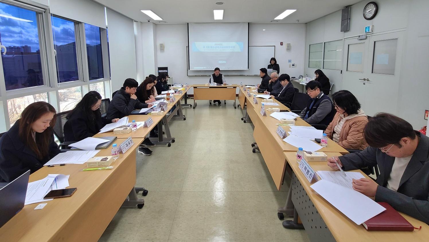 여러 명의 남자와 여자 위원이 모여서 회의하는 모습